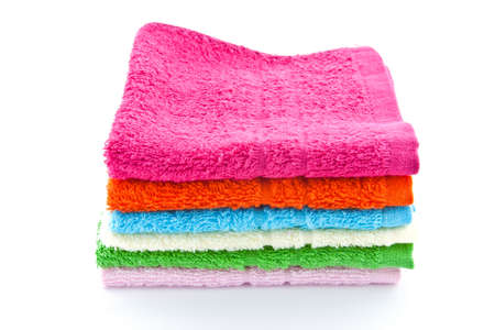 stacked colorful towels on a white backgroundの写真素材