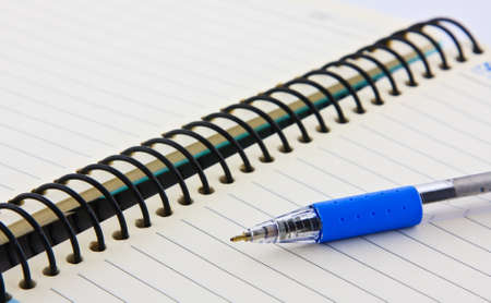 Notebook and pen on white isolatedの写真素材