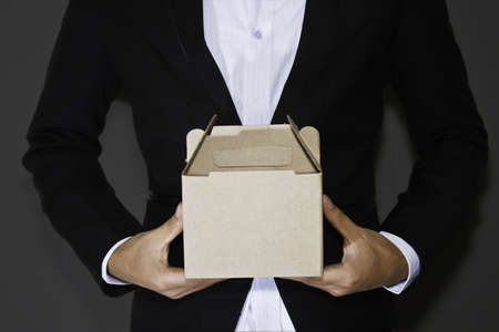 Business man carry boxの写真素材