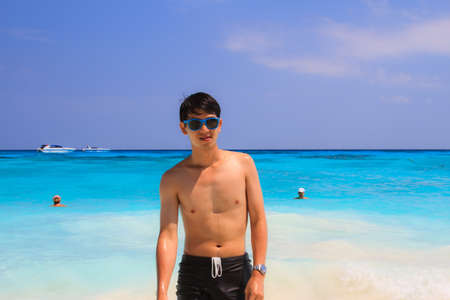 man on the beach with blue sky