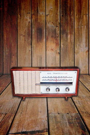 Old radio on wood background