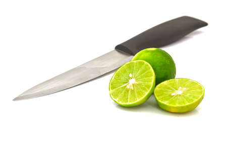 Limes and knife isolated on whiteの写真素材