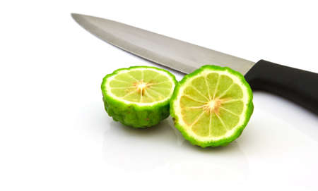 Kaffir Lime fruits with knife  isolated on white の写真素材