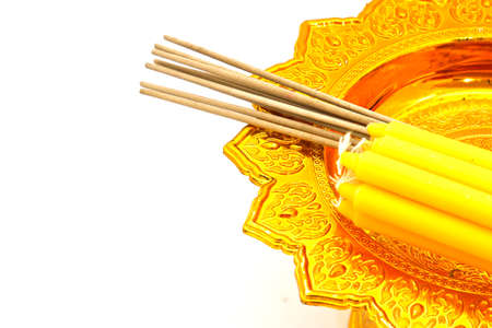 candle and incense on golden tray on whiteの写真素材