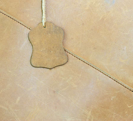 brown leather label on a brown bagの写真素材