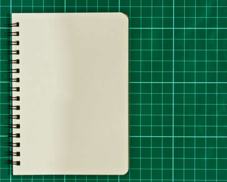 Open blank notebook on a cutting mat  の写真素材