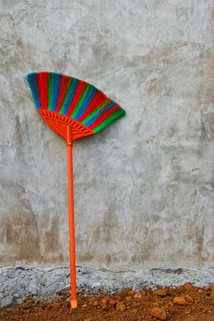 Red blue green plastic broomの写真素材