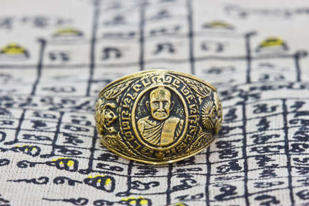 Thai amulet ring on backgroundの写真素材