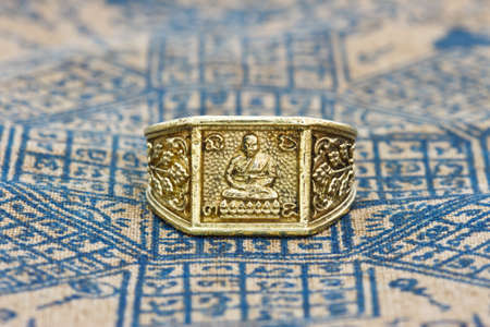 Thai amulet ring on backgroundの写真素材