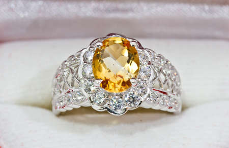 Yellow sapphire ring on whiteの写真素材