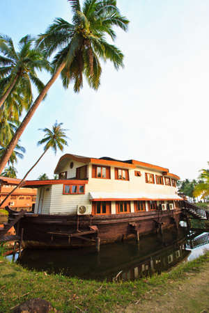 Wood boat is landing near the shore of the pondのeditorial素材