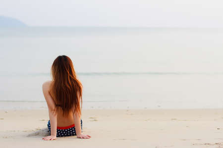 long haired woman in bikini on tropical beachの写真素材