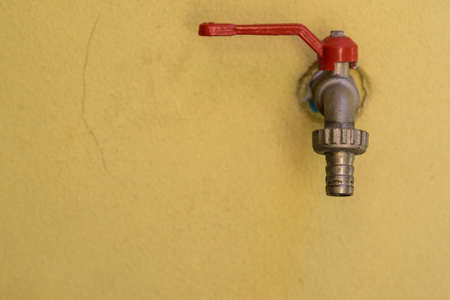 water valve with yellow blackgroundの写真素材