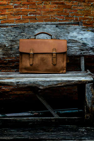 Brown Leather laptop bag corporate  on old woden chairの写真素材