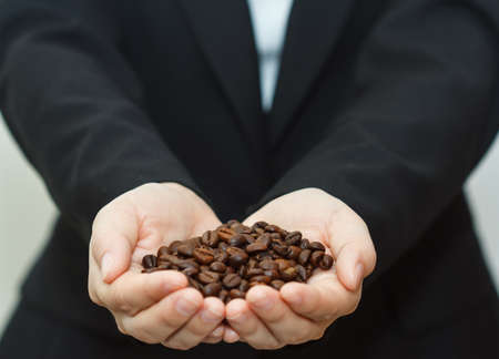 business woman holding coffee beans.の写真素材