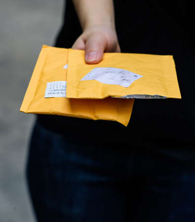 Delivery: Anonymous Delivery woman With Packageの写真素材