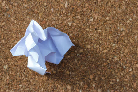 crumpled paper on wood backgroundの写真素材