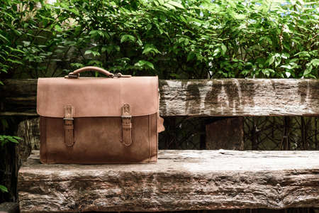 Brown Leather laptop bag corporate  on old woden chairの写真素材