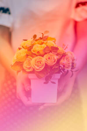 Young girl, holding vase with fresh spring flowersの写真素材