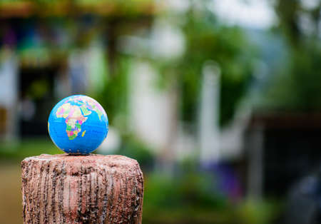 Globe lies on wooden tree . Elements of this image furnished by NASAの写真素材