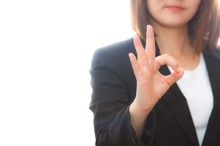 businesswoman with okay gesture, isolated on white backgroundの写真素材