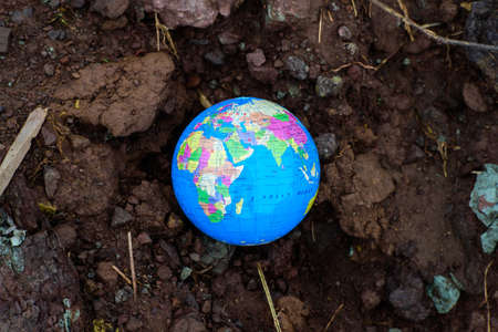 earth planet on dry soil. Elements of this image furnished by NASA