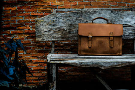 Brown Leather laptop bag corporate  on old woden chairの写真素材