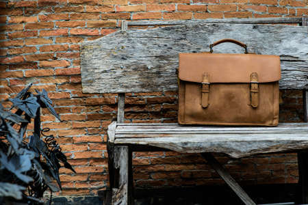 Brown Leather laptop bag corporate  on old woden chairの写真素材