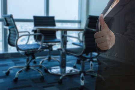 business woman thumb up show with meeting room focus Blur backgroundの写真素材