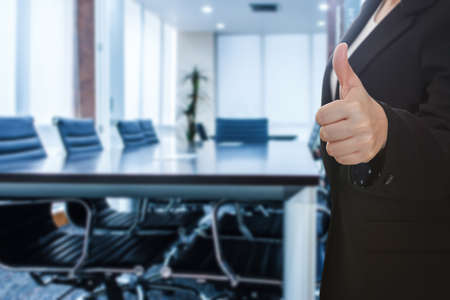 business woman thumb up show with meeting room focus Blur backgroundの写真素材
