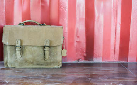 Brown Leather laptop bag corporate on old wooden floor.の写真素材