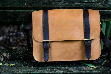 Brown Leather laptop bag corporate on old woden chairの写真素材