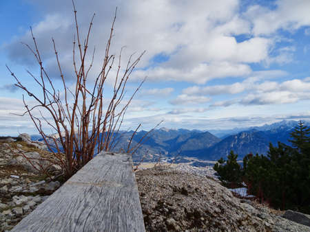 Bench in the foreground and mountain landscape in the backgroundの写真素材
