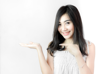 Beautiful woman presenting product on white backgroundの写真素材