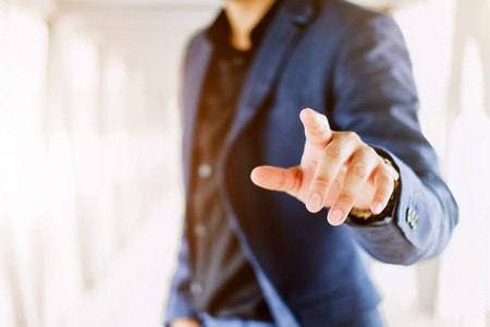 Blur businessman pushing on a touch screen interfaceの写真素材