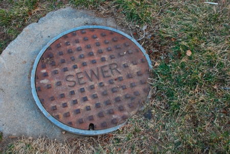 Metal sewer opening cover, in the front of a garden