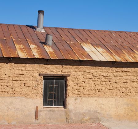 Grungy old brick building with metal roofの写真素材