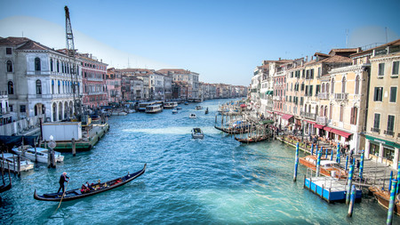 Venice, Italy - February 17, 2015:  Classical picture of the venetian canals with gondola across the canal.のeditorial素材