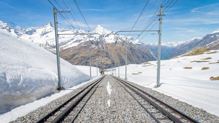 ZERMATT, SWITZERLAND - May 16. 2017: Red train climbing up to Gornergrat station on Zermatt, Switzerland. The Gornergrat rack railway is the highest open-air railway in Europe.のeditorial素材