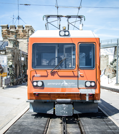 ZERMATT, SWITZERLAND - May 16. 2017: Red train climbing up to Gornergrat station on Zermatt, Switzerland. The Gornergrat rack railway is the highest open-air railway in Europe.のeditorial素材