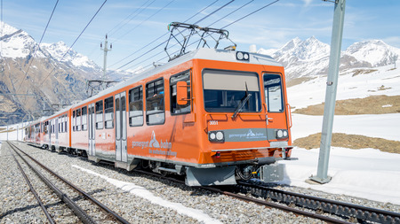 ZERMATT, SWITZERLAND - May 16. 2017: Red train climbing up to Gornergrat station on Zermatt, Switzerland. The Gornergrat rack railway is the highest open-air railway in Europe.のeditorial素材