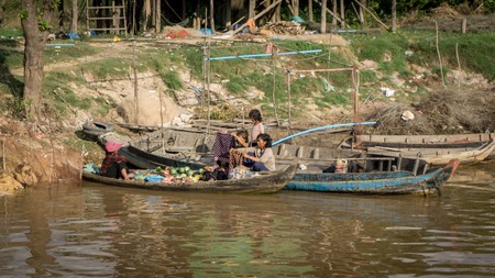 TONLE SAP LAKE, CAMBODIA , December 07, 2015: Local women working by a boat at the fisherman village of Kompong Khleang at Tonle Sap Lake, Cambodiaのeditorial素材