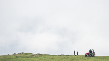 Giresun Turkey - June 2016: Farmers and a tractor on the top of a hillのeditorial素材
