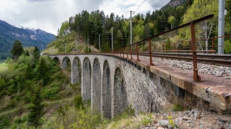 Albula - Switzerland - May 2017: Glacier train on famous landwasser Viaduct bridge.The Rhaetian Railway section from the Albula - Bernina area, Switzerland, Europe.のeditorial素材
