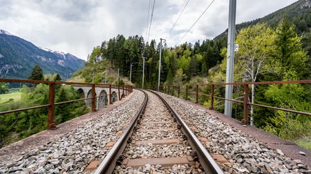 Albula - Switzerland - May 2017: Glacier train on famous landwasser Viaduct bridge.The Rhaetian Railway section from the Albula - Bernina area, Switzerland, Europe.のeditorial素材