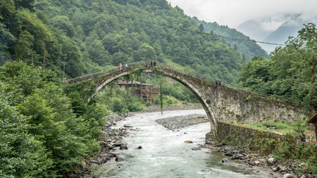 Camlihemsin, Rize, Turkey - July 2017: Historical Ottoman bridge Taskopru in Senyuva, Cinciva in Armenian, over the Firtina river near Camlihemsin in Rize province at the eastern end of Turkeyの写真素材