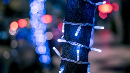 Closeup of a christmas new year tree in the street with blurred bokeh backgroundの写真素材