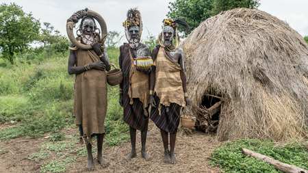 Mago National Park, Omo River Valley, Ethiopia - September 2017: Portrait of a Mursi woman. The women of the Mursi tribe have a lip plate and iron decorationsのeditorial素材
