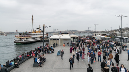 istanbul, Turkey - April 2018: Eminonu district in Istanbul with passenger ferry near the pier and human crowd, Istanbulのeditorial素材