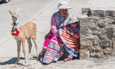Arequipa, Peru - September 2017: Peruvian woman with lama and alpaca.のeditorial素材